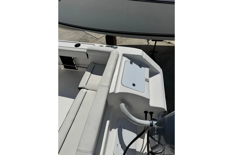 Slide: The Image of 2021 Tidewater 220 LXF boat interior with seating and storage compartment. - 3