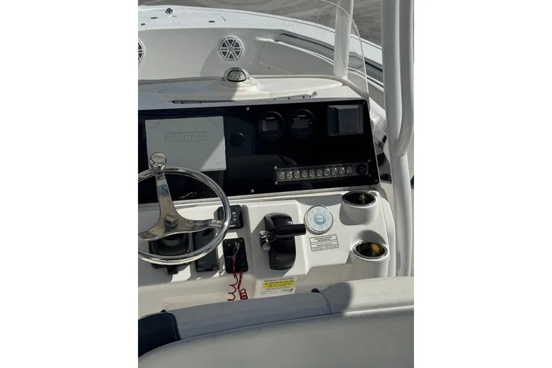 Slide: The Image of 2021 Tidewater 220 LXF boat dashboard with steering wheel and Simrad navigation system. - 5