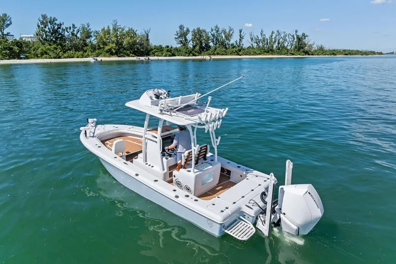 Slide: The Image of 2021 Barker Boatworks 26 Open on calm water near a lush shoreline. - 10