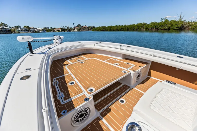Slide: The Image of 2021 Barker Boatworks 26 Open on serene water, showcasing spacious deck and sleek design. - 15
