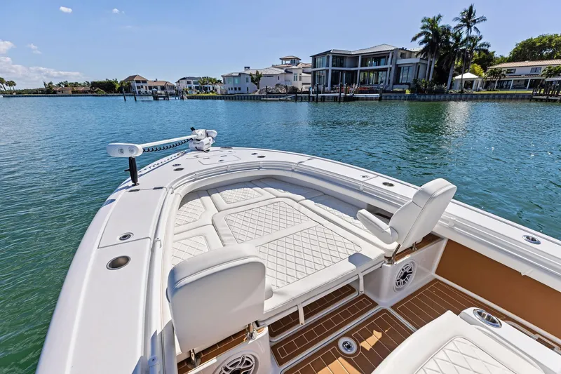Slide: The Image of 2021 Barker Boatworks 26 Open on serene water with luxury waterfront homes in background. - 16