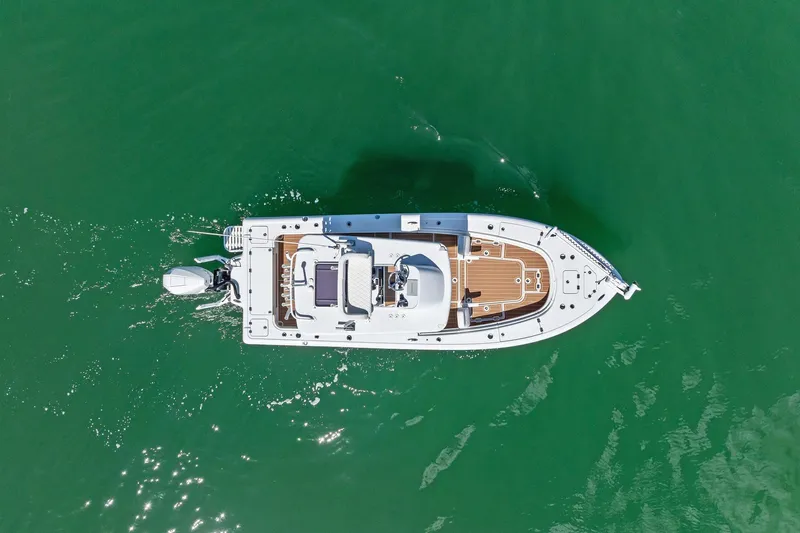 Slide: The Image of Aerial view of 2021 Barker Boatworks 26 Open on green water. - 2