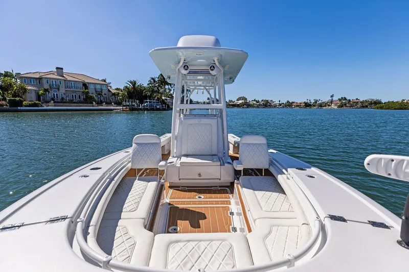 Slide: The Image of 2021 Barker Boatworks 26 Open on serene water with luxury seating and clear blue sky. - 21