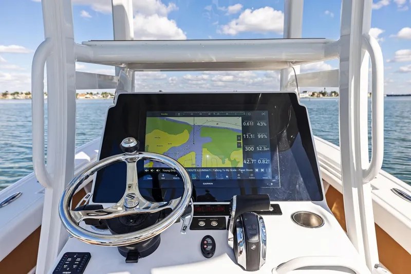 Slide: The Image of 2021 Barker Boatworks 26 Open helm with navigation display on calm water. - 27