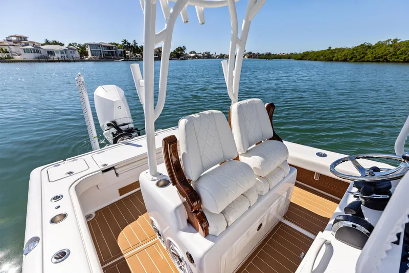 Slide: The Image of 2021 Barker Boatworks 26 Open with luxurious seating on a serene waterway. - 29