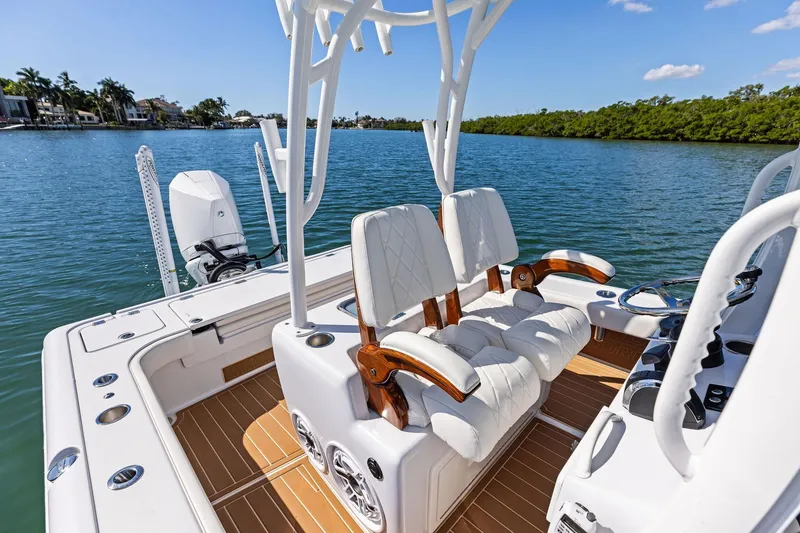 Slide: The Image of 2021 Barker Boatworks 26 Open with luxurious seating on a serene waterway. - 30