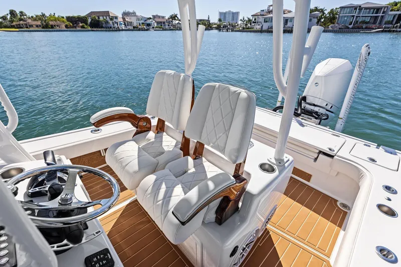 Slide: The Image of 2021 Barker Boatworks 26 Open interior with luxurious seating and scenic waterfront view. - 31