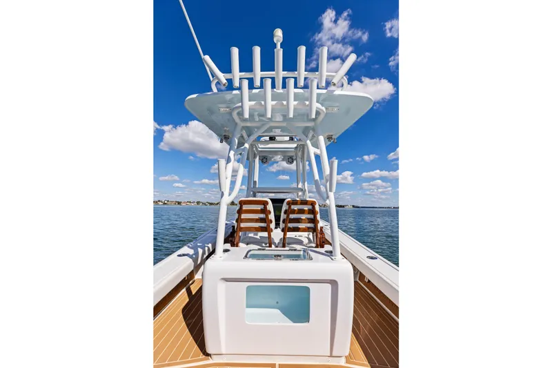 Slide: The Image of 2021 Barker Boatworks 26 Open on water, featuring sleek design and rod holders. - 36
