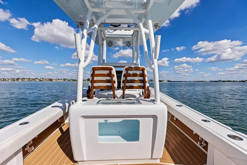 Slide: The Image of 2021 Barker Boatworks 26 Open on water, clear sky, wooden deck, dual seats. - 38