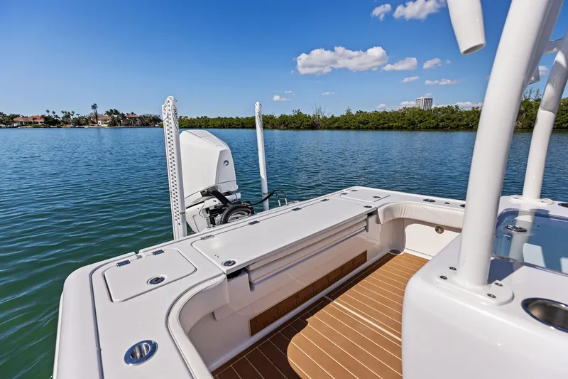 Slide: The Image of 2021 Barker Boatworks 26 Open on calm water, showcasing spacious deck and sleek design. - 40