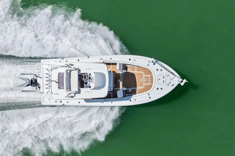 Slide: The Image of Aerial view of 2021 Barker Boatworks 26 Open cruising on green water. - 42
