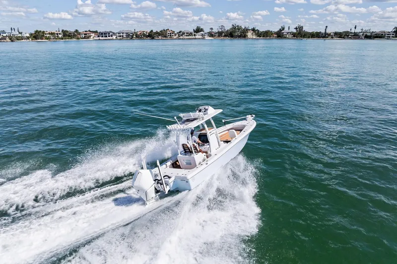 Slide: The Image of 2021 Barker Boatworks 26 Open cruising on clear blue water. - 47