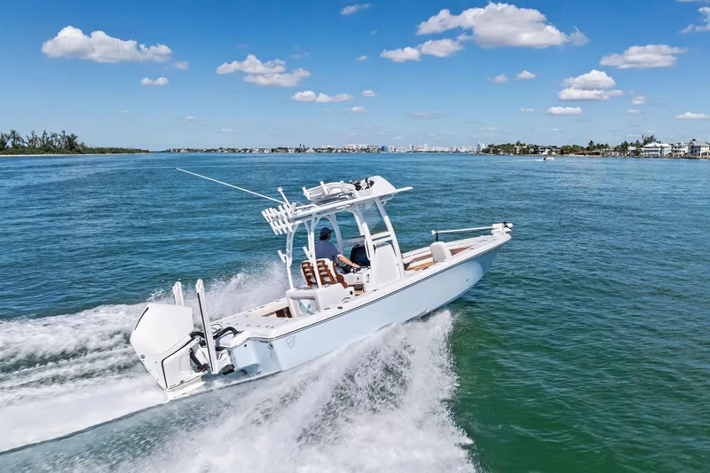Slide: The Image of 2021 Barker Boatworks 26 Open cruising on clear blue water under a sunny sky. - 48