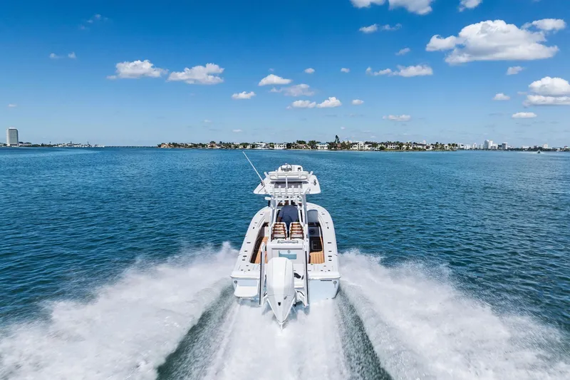 Slide: The Image of 2021 Barker Boatworks 26 Open cruising on clear blue water under a sunny sky. - 50
