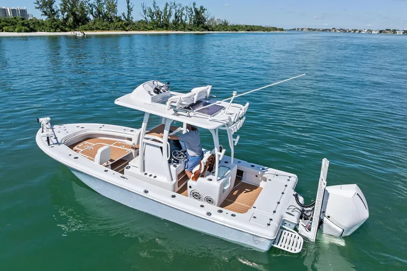 Slide: The Image of 2021 Barker Boatworks 26 Open cruising on clear blue water. - 8