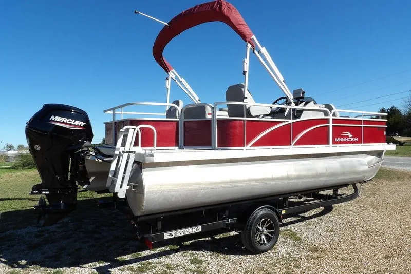 Slide: The Image of 2022 Bennington 20 SVF pontoon boat with red canopy and Mercury outboard motor. - 11