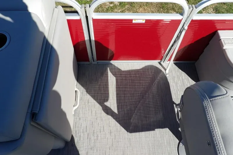 Slide: The Image of 2022 Bennington 20 SVF pontoon boat interior with red paneling and gray seating. - 20