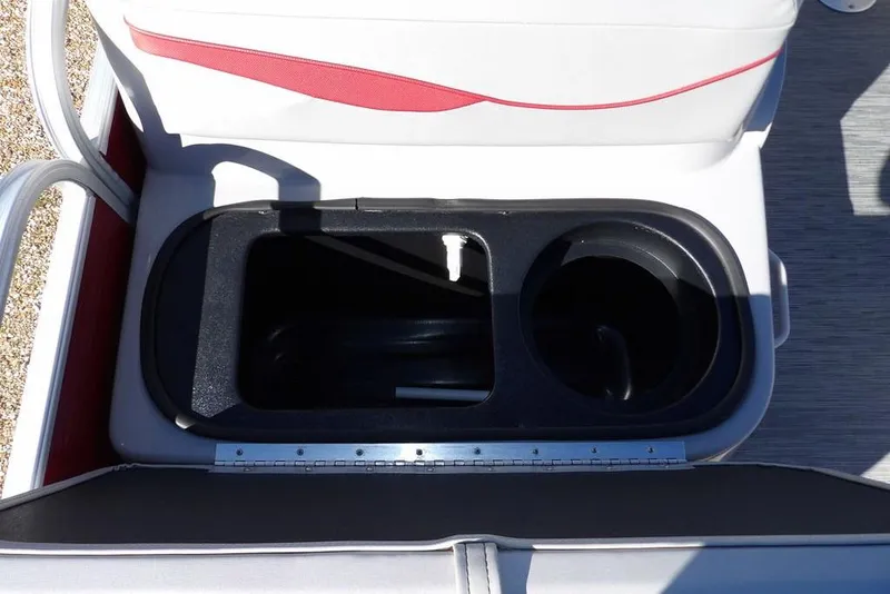 Slide: The Image of 2022 Bennington 20 SVF boat seat storage compartment with cup holder, featuring white and red upholstery. - 28