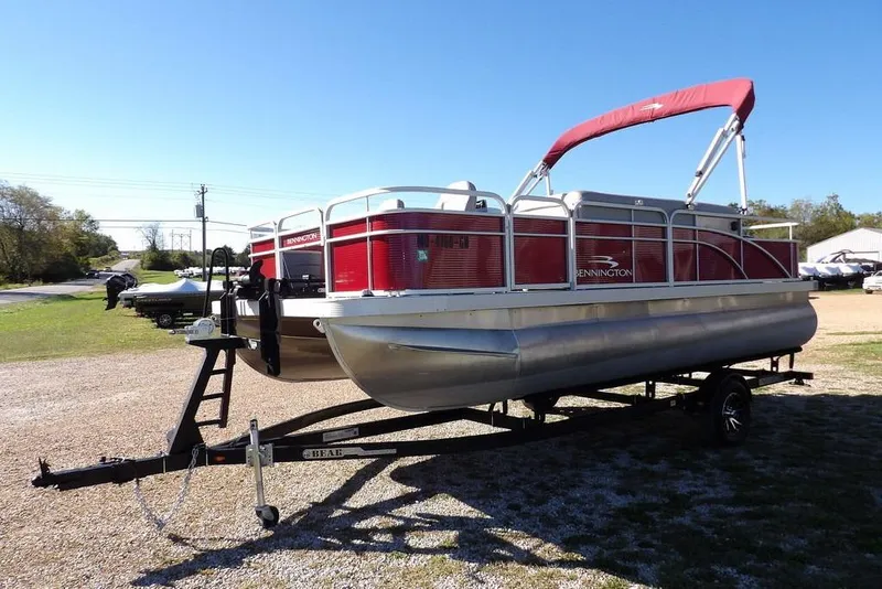 Slide: The Image of 2022 Bennington 20 SVF pontoon boat on trailer, red and silver design. - 3