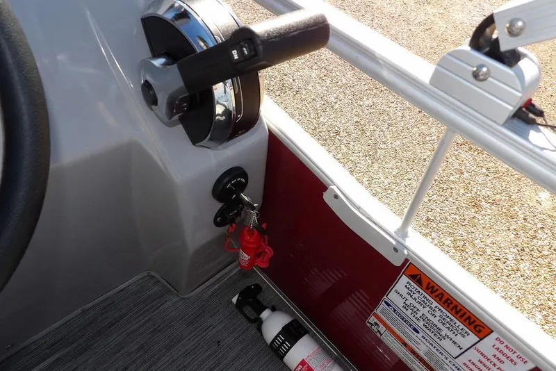 Slide: The Image of 2022 Bennington 20 SVF boat controls with safety key and warning labels. - 35