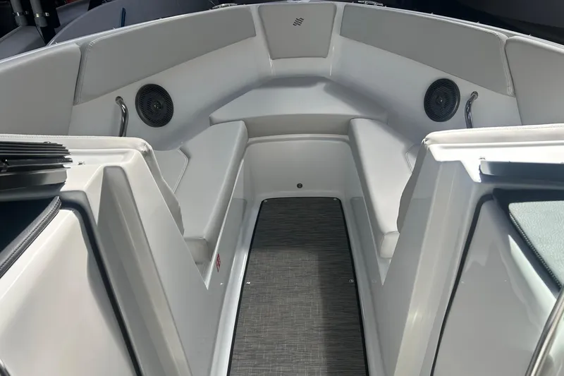 Slide: The Image of 2026 Four Winns H1 Freedom boat interior with cushioned seating and speakers. - 21