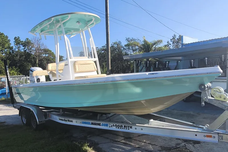 The Image of 2026 Savannah 220 IS boat on trailer, light blue hull, outdoor setting. - 1