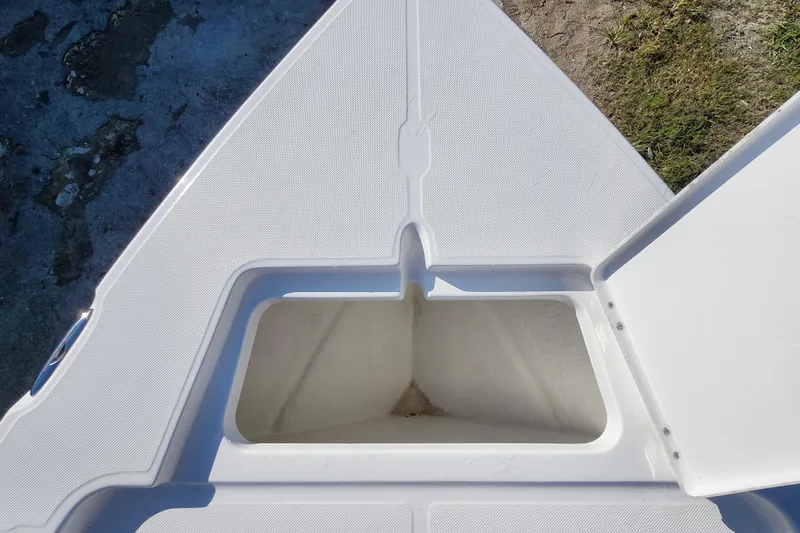 Slide: The Image of Open storage compartment on 2026 Savannah 220 IS boat deck. - 12