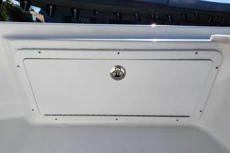 Slide: The Image of 2026 Savannah 220 IS boat storage compartment with secure latch. - 15