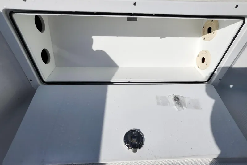 Slide: The Image of Open storage compartment on a 2026 Savannah 220 IS boat, featuring a secure latch. - 18