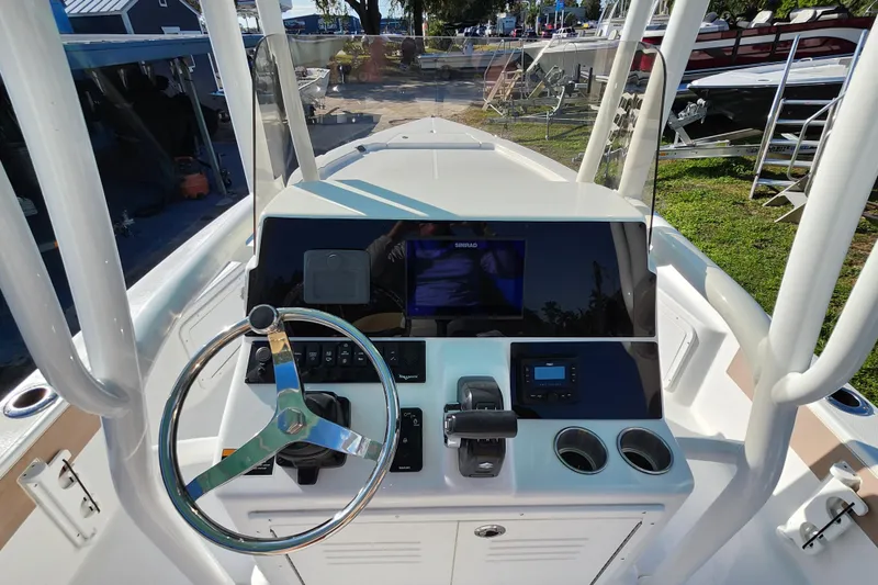 Slide: The Image of 2026 Savannah 220 IS boat dashboard with steering wheel and navigation controls. - 19