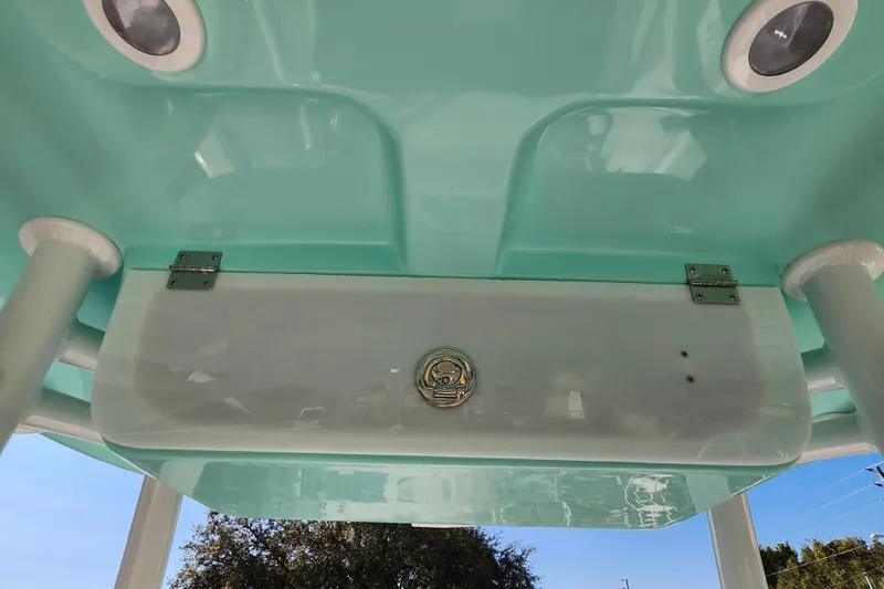 Slide: The Image of Underneath view of a 2026 Savannah 220 IS boat with teal accents and mounted lights. - 20