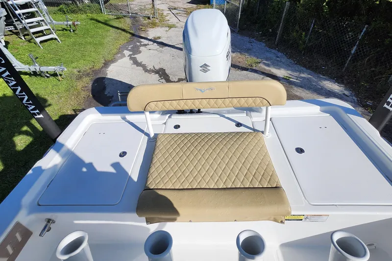 Slide: The Image of 2026 Savannah 220 IS boat with beige seating and Suzuki outboard motor. - 25