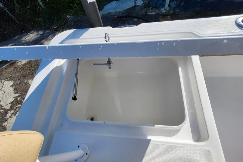 Slide: The Image of Livewell on a 2026 Savannah 220 IS boat, featuring a clean, white interior. - 27