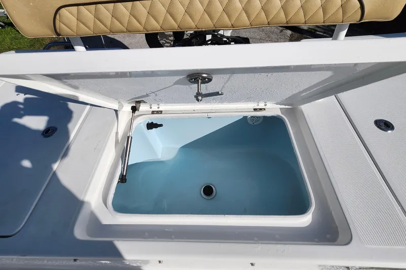 Slide: The Image of Open storage compartment on 2026 Savannah 220 IS boat with cushioned seating. - 30
