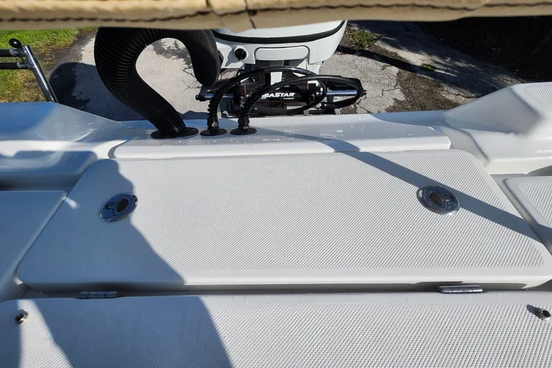 Slide: The Image of 2026 Savannah 220 IS boat deck with storage compartments and hydraulic steering system. - 31