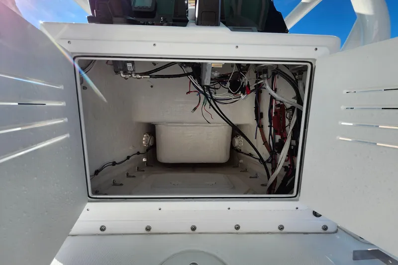 Slide: The Image of Open compartment of 2026 Savannah 220 IS boat showing internal wiring and components. - 39
