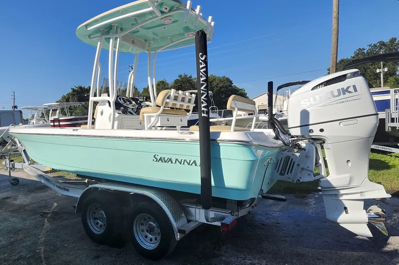 Slide: The Image of 2026 Savannah 220 IS boat with Suzuki engine on trailer, light blue hull. - 4