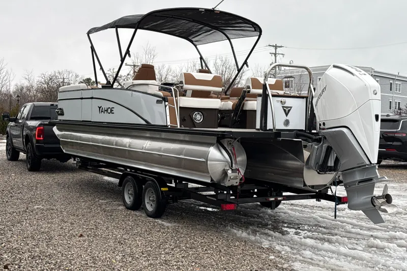 Slide: The Image of 2026 Tahoe Pontoon Cascade Quad Lounger Shift on trailer, parked on gravel. - 8
