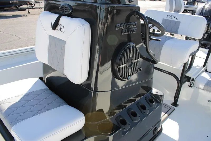 Slide: The Image of 2025 Excel Bay Pro Elite 230 boat interior with cushioned seating and console. - 13