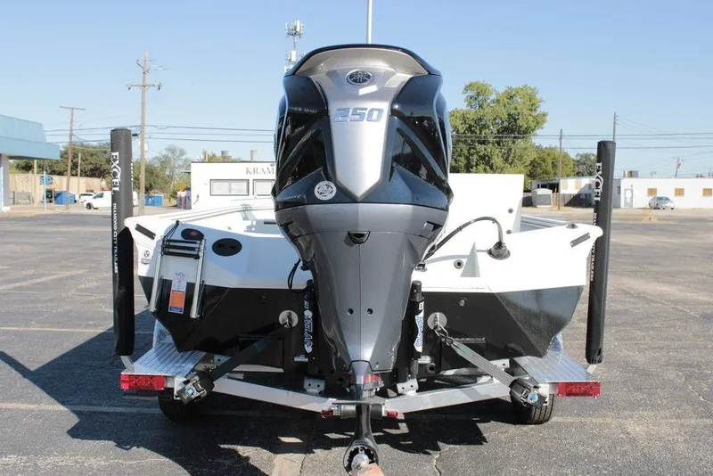 Slide: The Image of 2025 Excel Bay Pro Elite 230 boat with powerful outboard motor, parked on a trailer. - 8