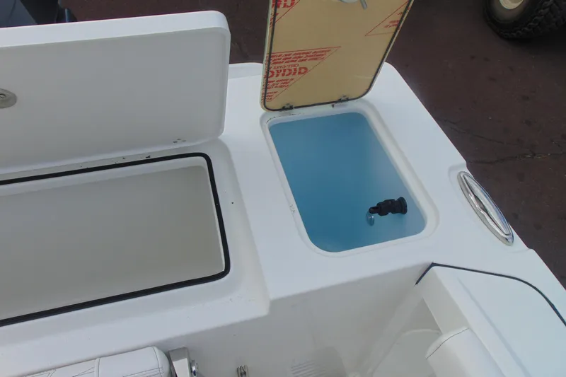 Slide: The Image of Open storage compartments on a 2026 Parker 247 Explorer boat deck. - 10