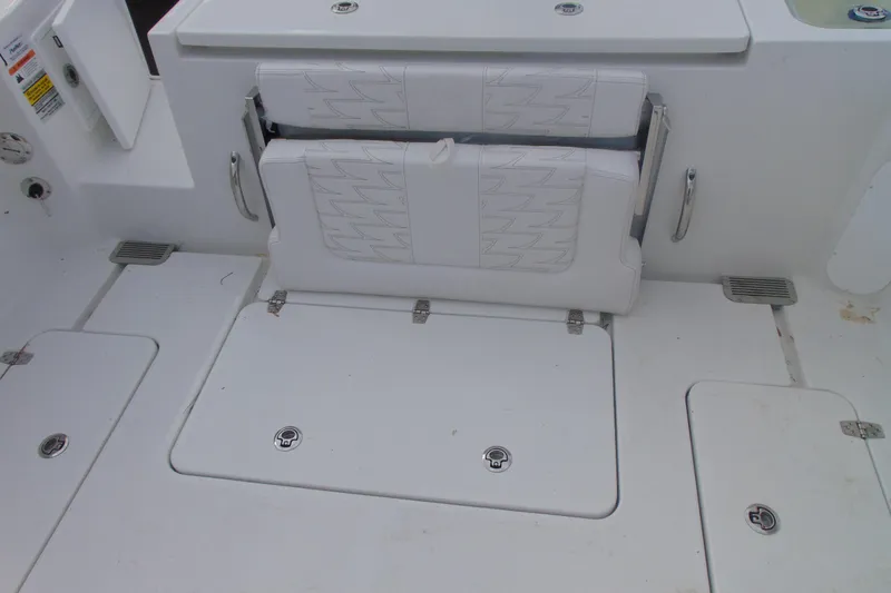Slide: The Image of 2026 Parker 247 Explorer boat interior with foldable seating and storage compartments. - 12