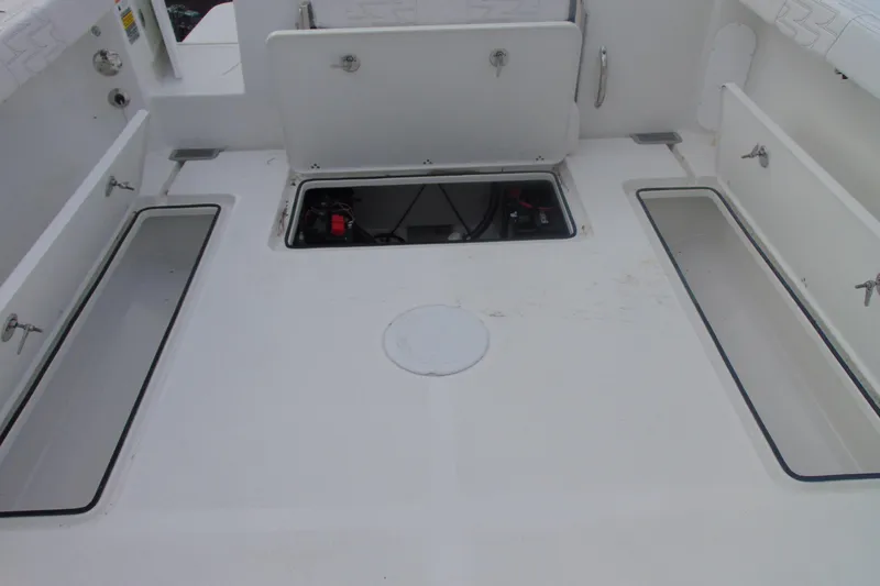 Slide: The Image of 2026 Parker 247 Explorer boat deck with open storage compartments. - 13