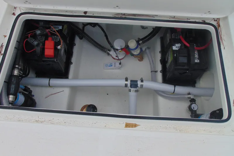 Slide: The Image of Battery compartment of 2026 Parker 247 Explorer boat, featuring wiring and plumbing components. - 14