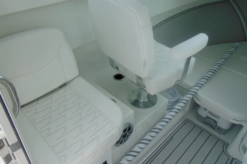 Slide: The Image of Interior of 2026 Parker 247 Explorer boat with white seating and modern design. - 17