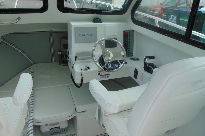 Slide: The Image of Interior of 2026 Parker 247 Explorer boat with Garmin navigation system and white seating. - 18