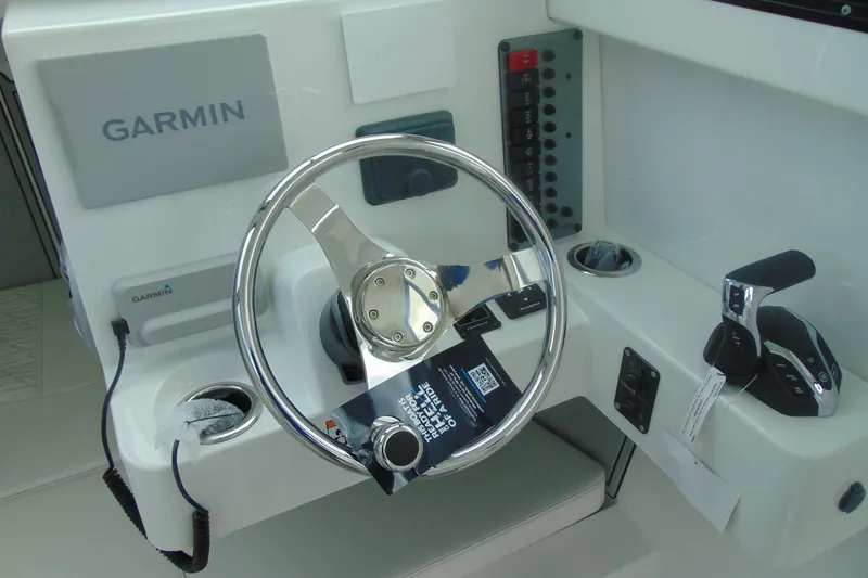 Slide: The Image of 2026 Parker 247 Explorer boat dashboard with Garmin navigation system and steering wheel. - 19