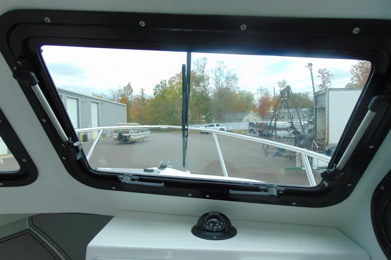 Slide: The Image of Interior view from 2026 Parker 247 Explorer boat, showing windshield and compass. - 23