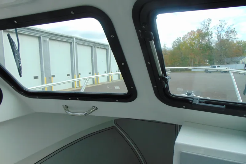 Slide: The Image of Interior view of 2026 Parker 247 Explorer boat with large windows and outdoor scenery. - 24
