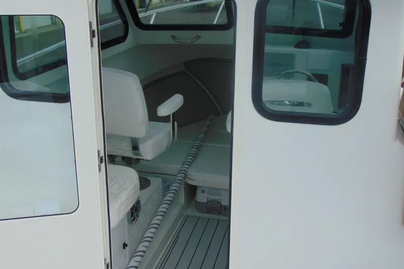 Slide: The Image of Interior view of 2026 Parker 247 Explorer boat, featuring seating and helm area. - 7
